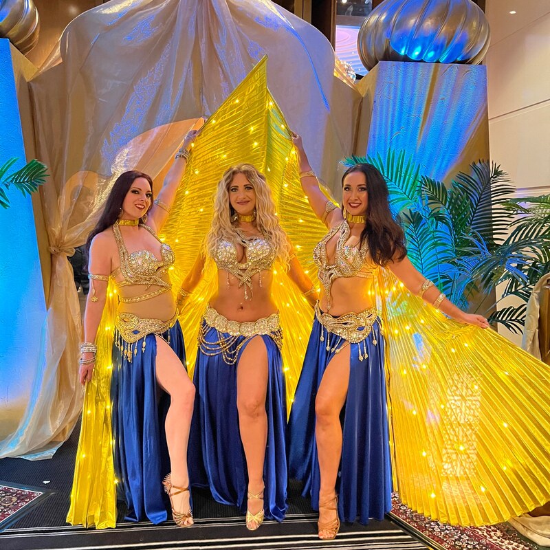 Gold winged belly dance performance with live drummers